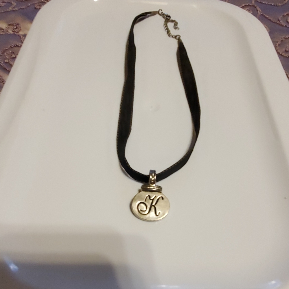 Ribbon K necklace.